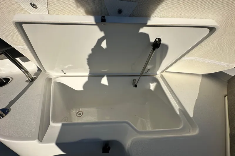 Slide: The Image of Open storage compartment on 2025 Sea Hunt Ultra 219 boat, showcasing interior space. - 47