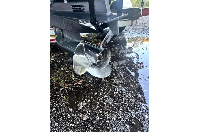 Slide: The Image of 2025 Sea Hunt Ultra 219 boat on trailer at dealership, sunny day. - 5