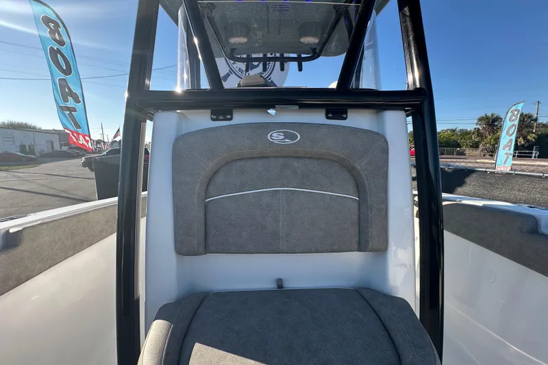 Slide: The Image of 2025 Sea Hunt Ultra 219 boat interior with seating and console, displayed outdoors. - 51