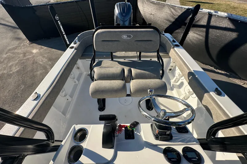 Slide: The Image of 2025 Sea Hunt Ultra 219 boat interior with steering wheel and seating. - 54