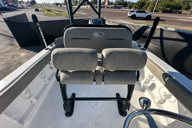 Slide: The Image of 2025 Sea Hunt Ultra 219 boat interior with cushioned seating and steering wheel. - 55