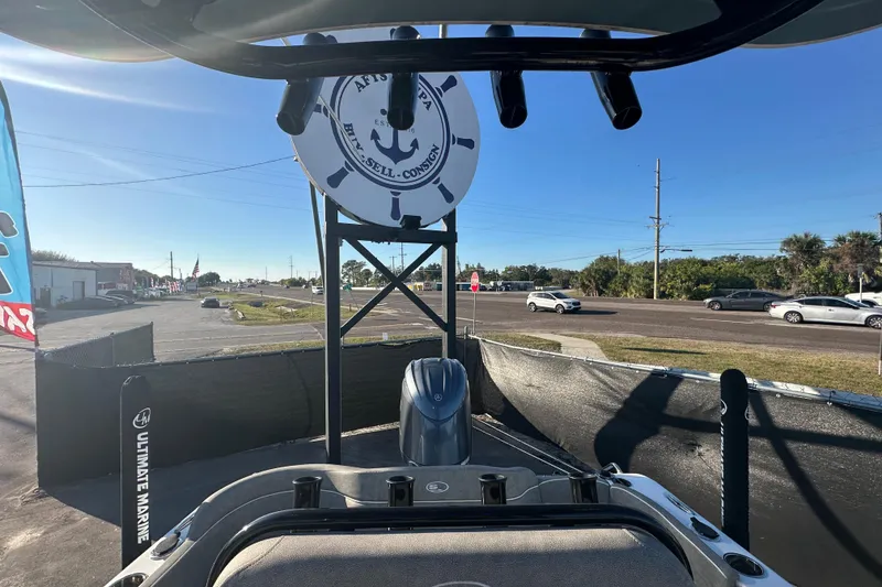 Slide: The Image of Sea Hunt Ultra 219 boat displayed outdoors at a marine dealership, 2025 model. - 56