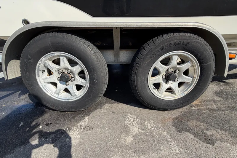 Slide: The Image of 2025 Sea Hunt Ultra 219 boat with Yamaha engine on trailer, sunny day. - 6