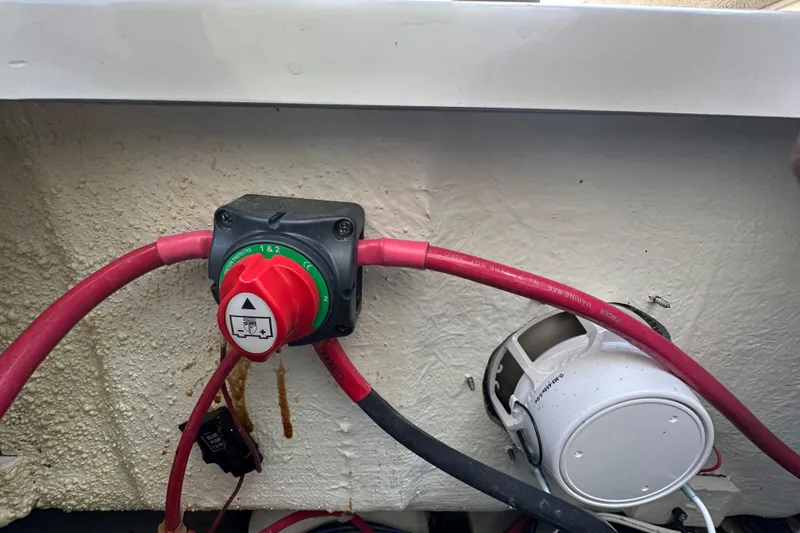 Slide: The Image of Battery switch and wiring inside a 2025 Sea Hunt Ultra 219 boat. - 60