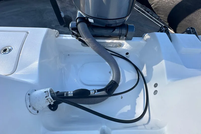 Slide: The Image of 2025 Sea Hunt Ultra 219 boat engine compartment with cables and hoses. - 66
