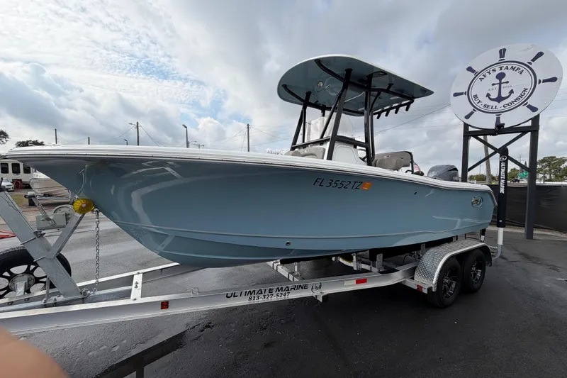 Slide: The Image of 2025 Sea Hunt Ultra 219 boat with Yamaha 200 engine at a boat sale event. - 8