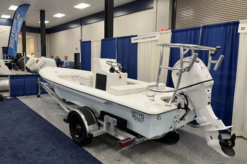 Slide: The Image of 2026 Delta Boatworks Delta D18 displayed at a boat show, featuring a sleek design and Yamaha engine. - 12