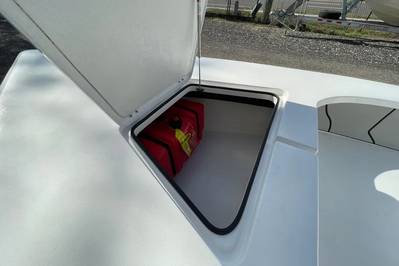Slide: The Image of Open storage compartment on 2026 Delta Boatworks Delta D18, featuring a red fuel container. - 8