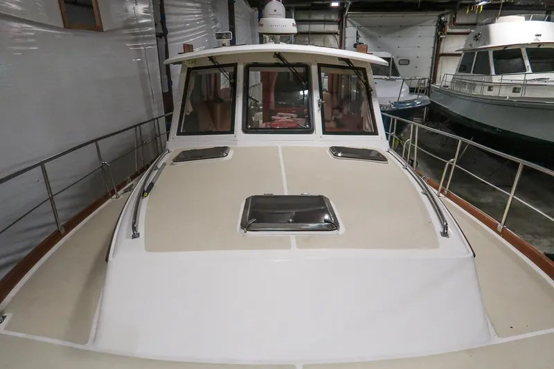 Slide: The Image of 2007 Grand Banks 39 Eastbay SX yacht in indoor storage, showcasing deck and cabin. - 15