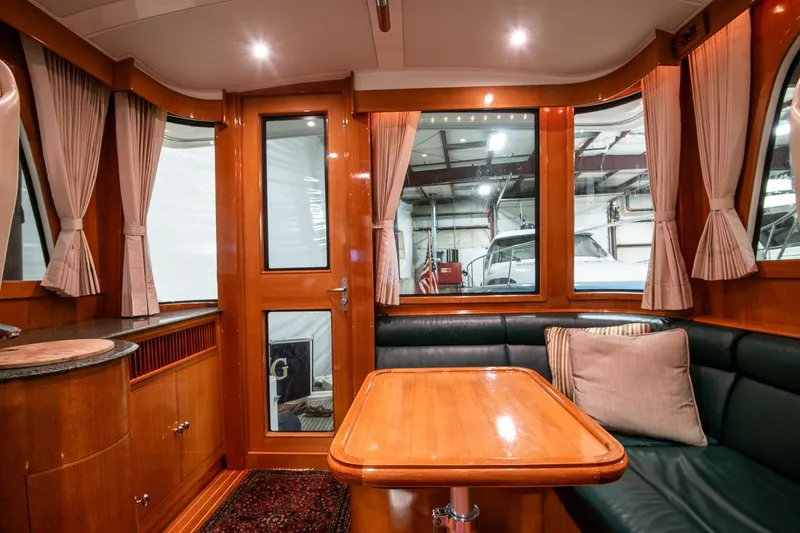 Slide: The Image of Luxurious interior of 2007 Grand Banks 39 Eastbay SX yacht with wood finishes and seating area. - 20