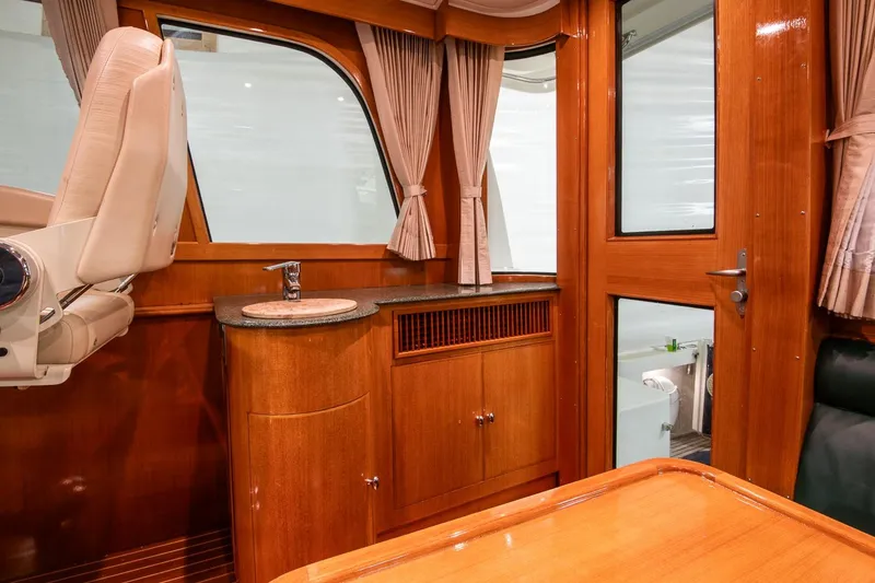 Slide: The Image of Interior of 2007 Grand Banks 39 Eastbay SX with wood finish and compact sink area. - 21