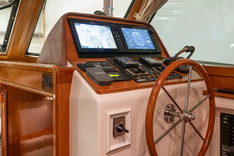 Slide: The Image of 2007 Grand Banks 39 Eastbay SX helm with navigation screens and wooden steering wheel. - 24