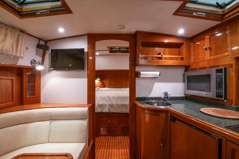 Slide: The Image of Luxurious 2007 Grand Banks 39 Eastbay SX yacht interior with kitchenette and cozy seating area. - 26