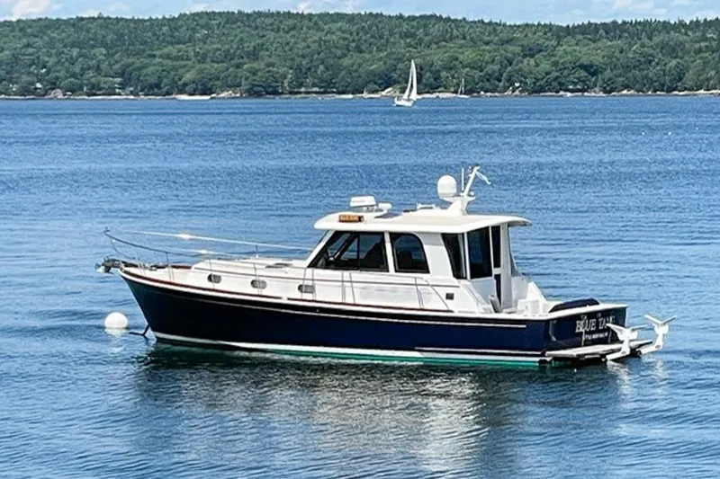 Slide: The Image of 2007 Grand Banks 39 Eastbay SX yacht on calm water, scenic background. - 3