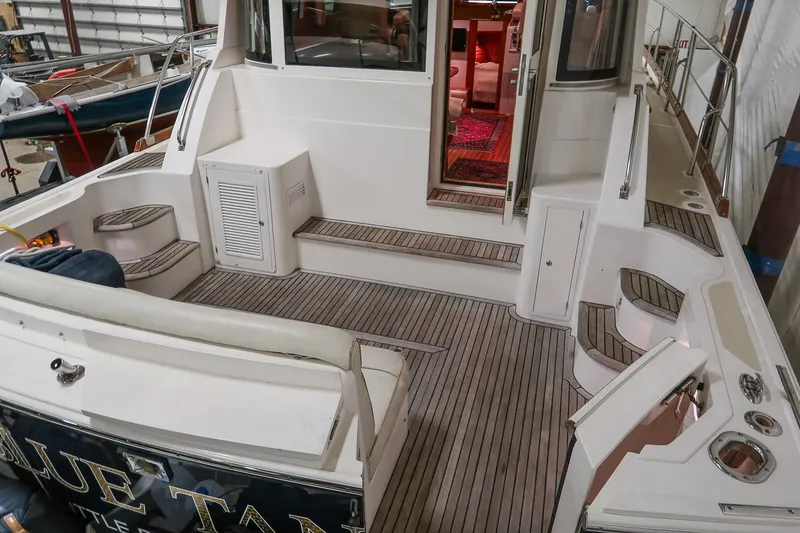 Slide: The Image of 2007 Grand Banks 39 Eastbay SX yacht interior with teak flooring and seating area. - 9