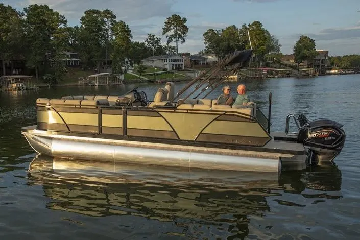 Slide: The Image of 2026 Veranda Relax VR235RCP pontoon boat on a serene lake with two passengers. - 8