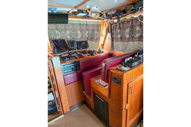 Slide: The Image of Interior of 1996 Lafitte Skiff 48 boat with navigation equipment and wooden paneling. - 5