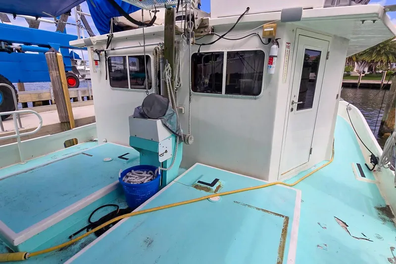 Slide: The Image of 1996 Lafitte Skiff 48 boat deck with cabin, docked at marina. - 8