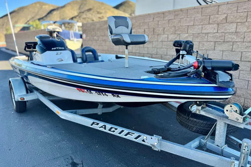 Slide: The Image of 2015 Nitro Z-7 boat on trailer, parked outdoors with mountains in background. - 1