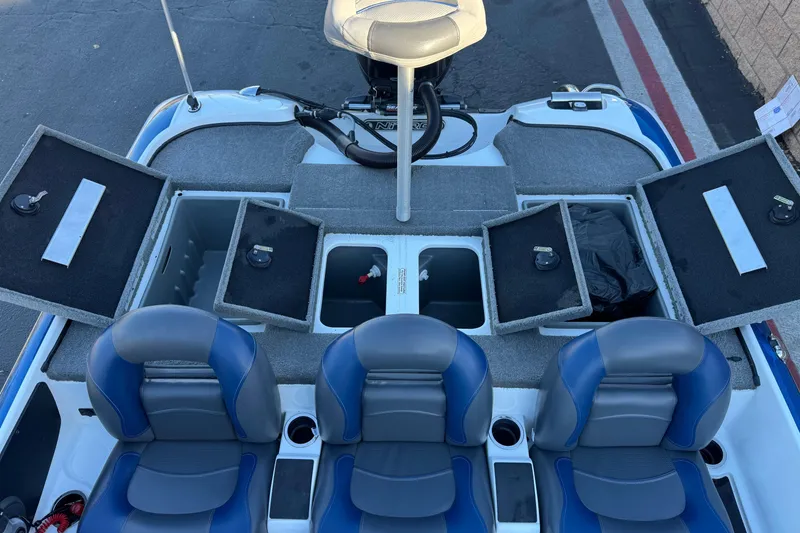 Slide: The Image of 2015 Nitro Z-7 boat interior with open storage compartments and blue-gray seating. - 17