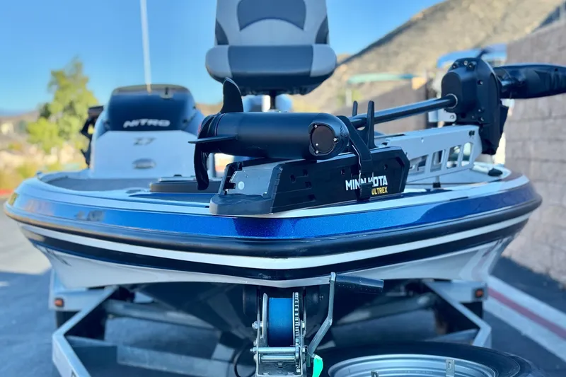 Slide: The Image of 2015 Nitro Z-7 boat with Minn Kota Ultrex motor, parked outdoors. - 3