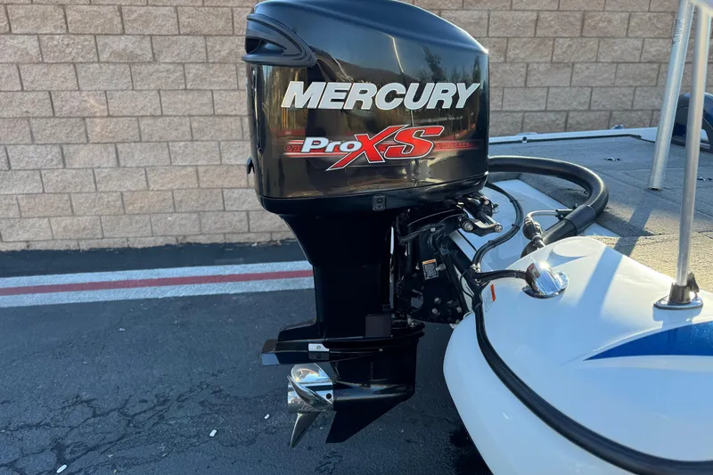 Slide: The Image of Mercury Pro XS outboard motor on 2015 Nitro Z-7 boat, parked on pavement. - 7