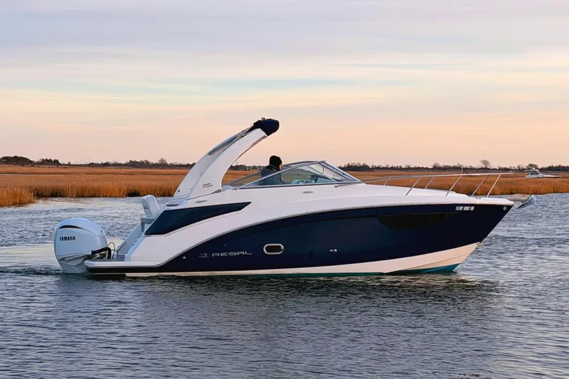 The Image of 2022 Regal 26 XO boat with Yamaha engine on calm water. - 1