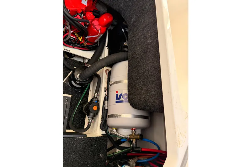 Slide: The Image of Engine compartment of a 2022 Regal 26 XO boat, featuring mechanical components and wiring. - 18