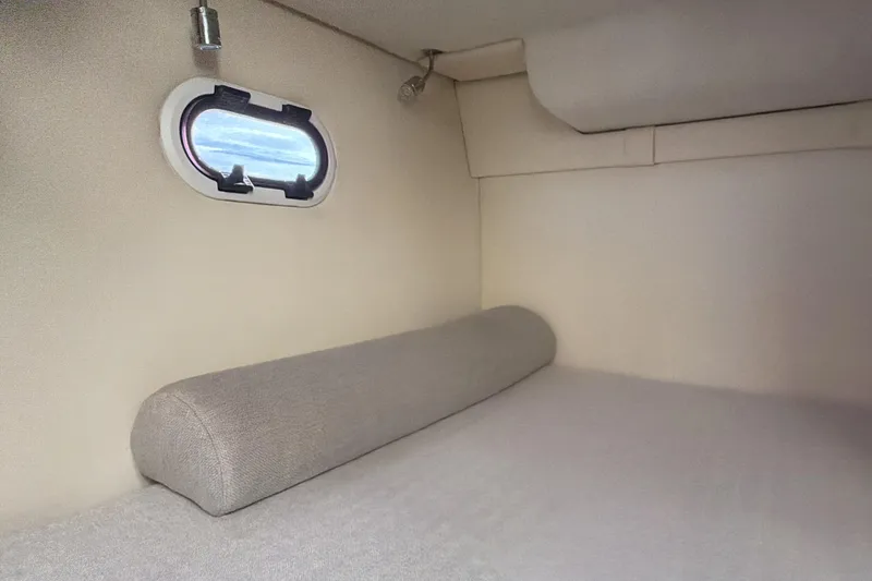 Slide: The Image of Interior cabin of 2022 Regal 26 XO boat with window and cushioned seating. - 27