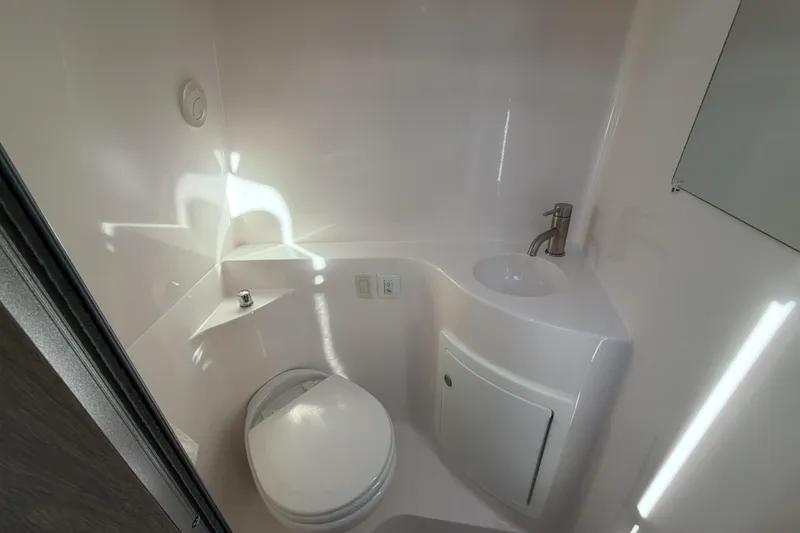 Slide: The Image of 2022 Regal 26 XO boat bathroom with toilet, sink, and modern fixtures. - 30