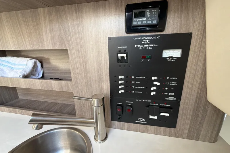 Slide: The Image of 2022 Regal 26 XO boat control panel with sink and storage shelf. - 32
