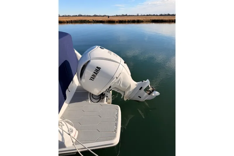 Slide: The Image of 2022 Regal 26 XO boat with Yamaha outboard motor on calm water. - 6
