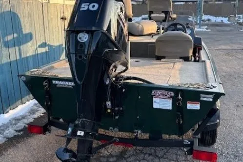 Slide: The Image of 2026 Tracker Bass Tracker Classic Limited boat with 50 HP motor, parked outdoors. - 3