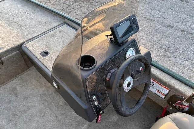 Slide: The Image of 2026 Tracker Bass Tracker Classic Limited boat console with steering wheel and navigation system. - 8