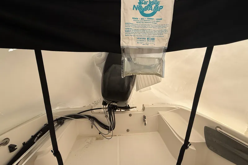 Slide: The Image of 2011 Boston Whaler 150 Super Sport interior with moisture absorber bag. - 4