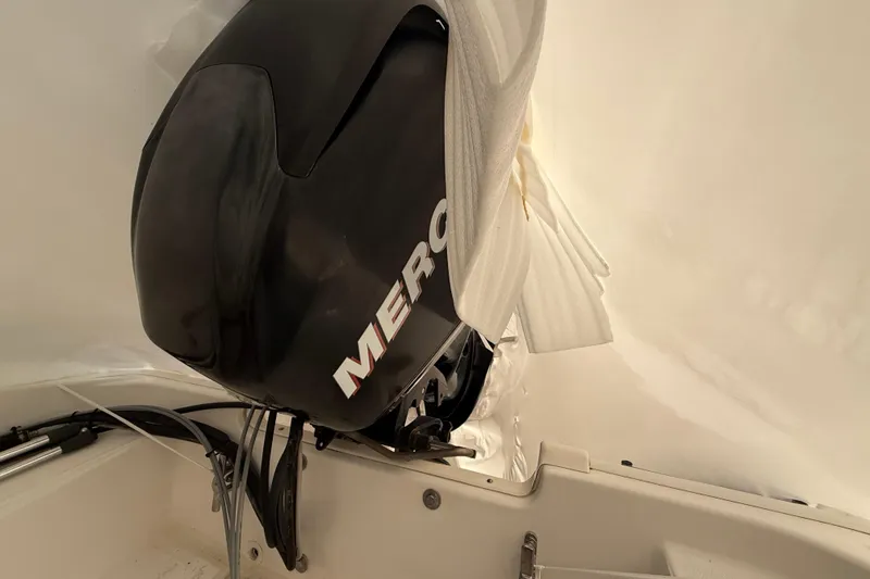 Slide: The Image of 2011 Boston Whaler 150 Super Sport with Mercury outboard engine, partially covered. - 6