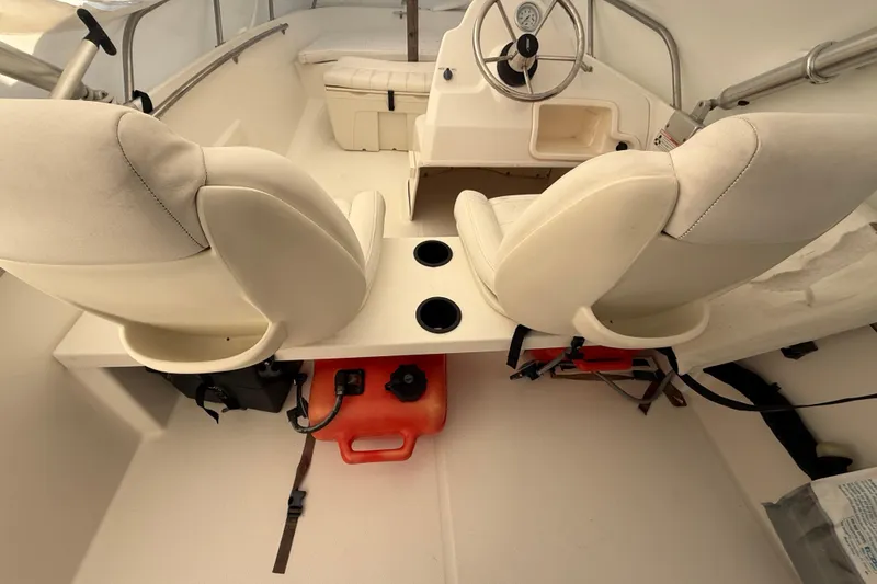 Slide: The Image of 2011 Boston Whaler 150 Super Sport interior with dual seats and steering console. - 7