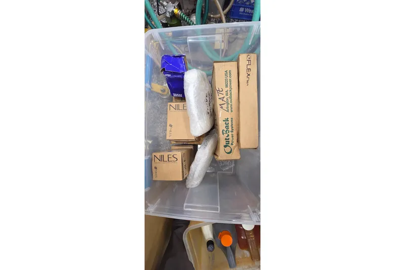 Slide: The Image of Plastic container with various boxed items and wrapped packages, Leopard 47, 2004 model. - 100