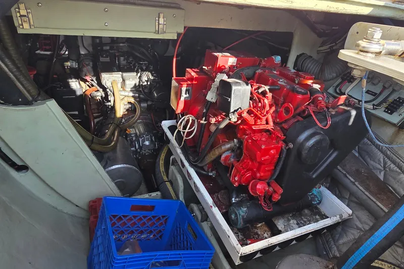 Slide: The Image of Engine compartment of a 2004 Leopard 47 catamaran with visible red engine components. - 13
