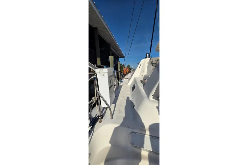 Slide: The Image of 2004 Leopard 47 yacht deck view under clear blue sky. - 14