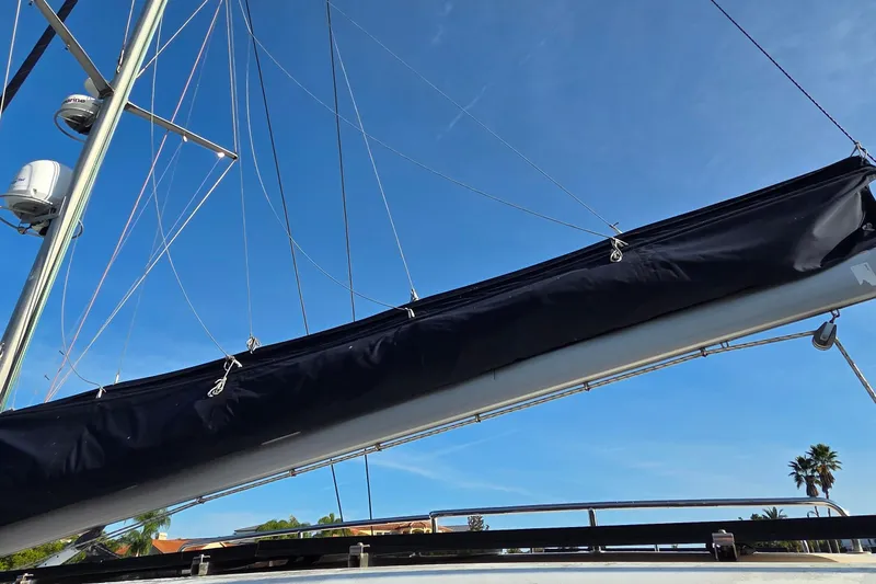 Slide: The Image of Sailboat mast and boom of a 2004 Leopard 47 under clear blue sky. - 17