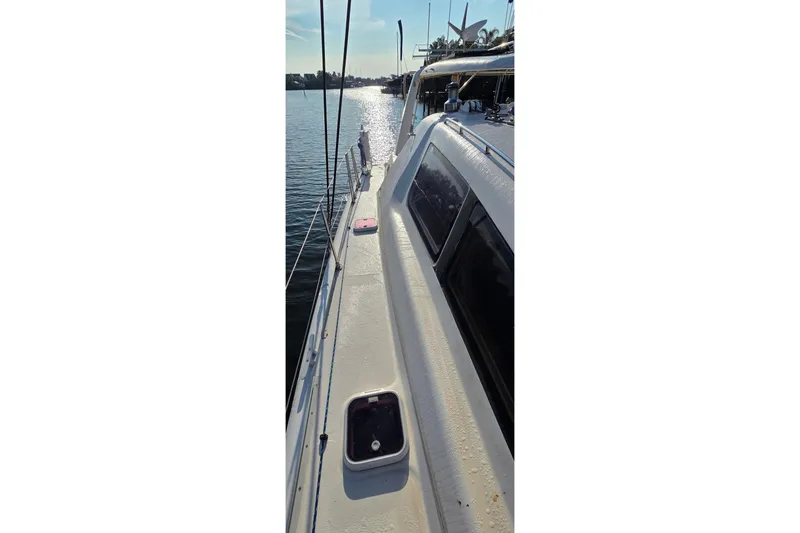Slide: The Image of 2004 Leopard 47 catamaran deck with ocean view and sunlight reflections. - 27