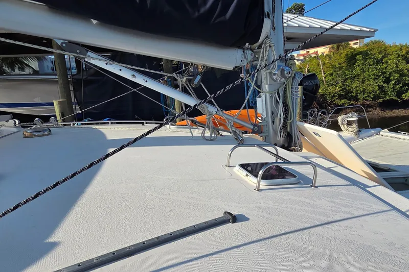 Slide: The Image of Deck view of a 2004 Leopard 47 catamaran with rigging and hatch details. - 29