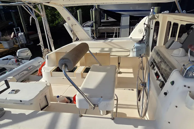 Slide: The Image of 2004 Leopard 47 yacht cockpit with steering wheel and seating area. - 31