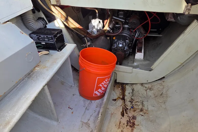 Slide: The Image of Engine compartment of a 2004 Leopard 47 with an orange bucket and equipment. - 33