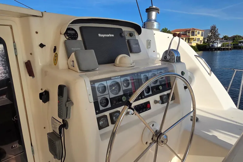 Slide: The Image of Helm of 2004 Leopard 47 yacht with navigation equipment and steering wheel. - 35