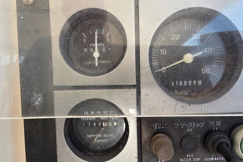 Slide: The Image of Close-up of a 2004 Leopard 47 control panel with gauges and switches. - 36