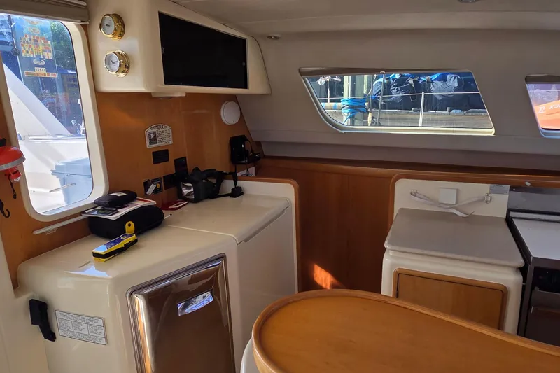 Slide: The Image of Interior of a 2004 Leopard 47 yacht with modern amenities and wooden accents. - 39