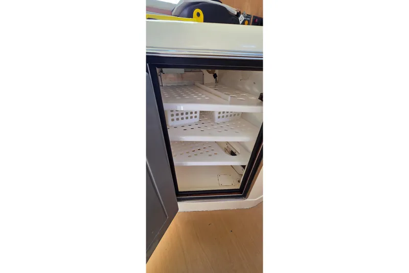 Slide: The Image of Open refrigerator with empty shelves on a 2004 Leopard 47 yacht. - 41
