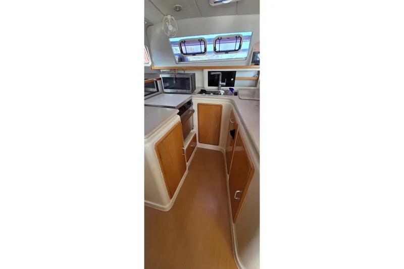 Slide: The Image of Interior of 2004 Leopard 47 yacht kitchen with wooden cabinets and modern appliances. - 42